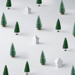 Winter landscape made of Christmas trees and paper houses. Minimal New Year nature background.