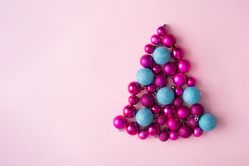 Minimal Christmas tree made of plastic pink and blue decorative Christmas balls. New Year concept.
