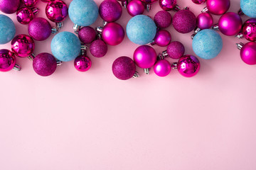 Minimal composition background of plastic pink and blue decorative Christmas balls. New Year concept.