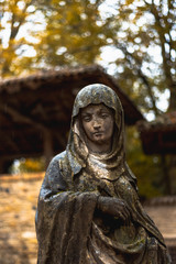 Statue of a woman under the rain in autumn Italy