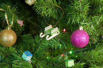 Wooden toy baby sled on the Christmas tree