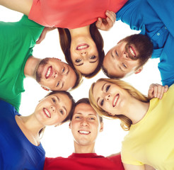 Large group of smiling friends staying together and looking at camera isolated on white background.