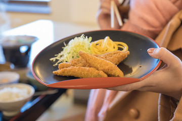 people is preparing food in pan