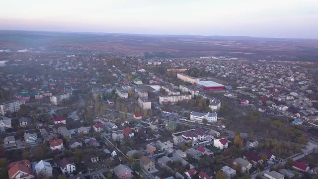 aerial flying shot over suburban area, streets, and houses