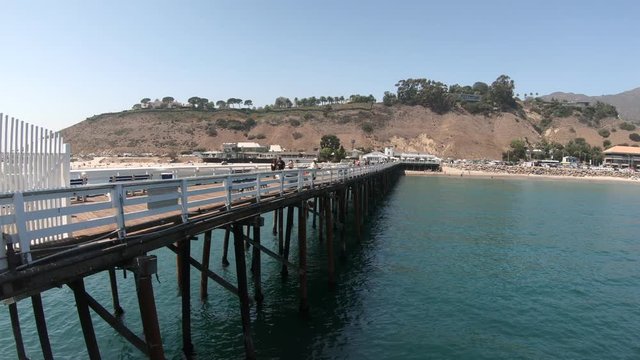 Scenic coastal landscape of Malibu Pier in Malibu, California, United States see from Carbon Beach. Malibu Pier is an historic landmark.