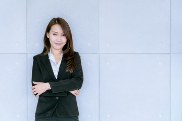 Asian beatiful young business woman in suit skirt using tablet to work about sales and marketing plan