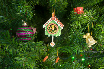 Wooden toy clock with pendulum on Christmas tree