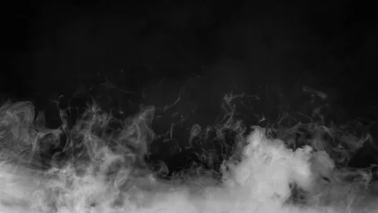 Poster Rolling billows of smoke mist clouds from dry ice across the bottom light . Fog on floor isolated background  black texture . © Victor