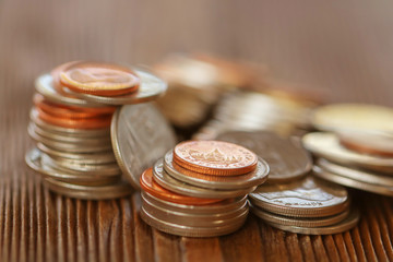 Row of coins on wood background for finance and Saving concept,Investment, Economy, Soft focus and dark style.