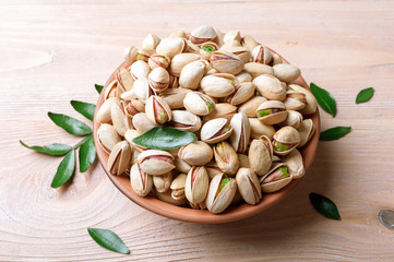 Pistachios nuts in bowl. Pistachio background. Healthy food, snacks, vegetarian food