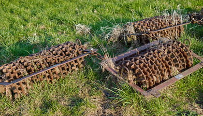 Farm implements: Old and rusty Cambridge roller on a meadow