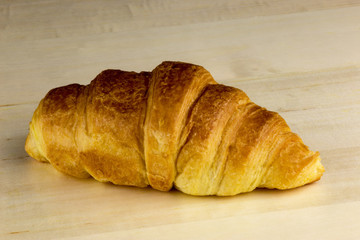 Fresh Croissant on a Wooden Table Surface