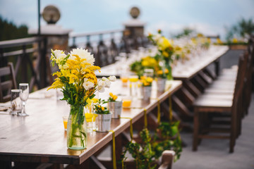 Table set up for a special event/wedding. Yellow and green fresh flowers
