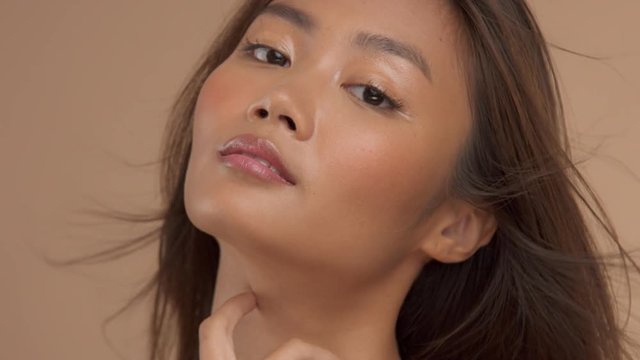closeup thai asian model posas with blowing hair