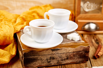 Two cups of coffee espresso near sugar cube