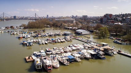 Fototapeta na wymiar River marina with many boats white clouds and blue sky in Belgrade