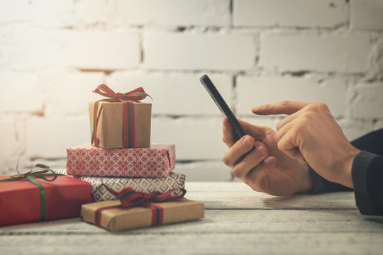 man using smartphone to buy gifts online at internet store