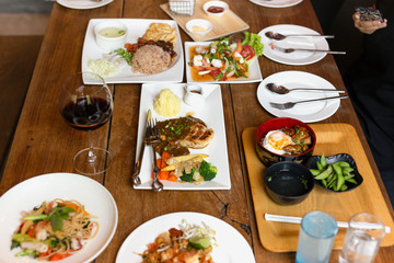 Mixes variety food on wooden table with red wine top view.