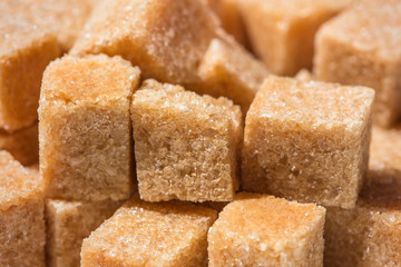 brown cube sugar close-up background with detailed crystal structure