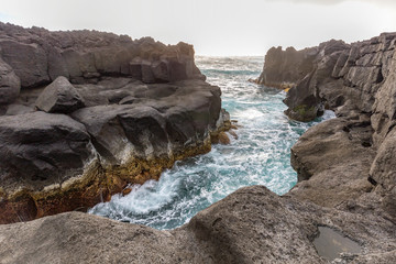 A volcanic coastal landscape near the Piscina Natural da Ponta da Ferraria.