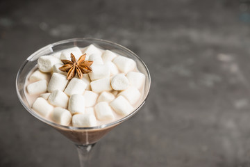 Chocolate martini with spices and marshmallow on the rustic background. Selective focus. Shallow depth of field. 