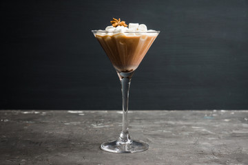 Chocolate martini with spices and marshmallow on the rustic background. Selective focus. Shallow depth of field. 