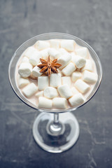 Chocolate martini with spices and marshmallow on the rustic background. Selective focus. Shallow depth of field. 