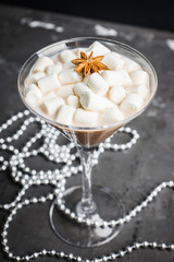 Chocolate martini with spices and marshmallow on the rustic background. Selective focus. Shallow depth of field. 
