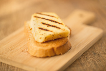 Toast with fried grill cheese on cutting board