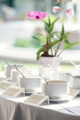 flowers and seasoning bowls at breakfast in the garden of resort or hotel