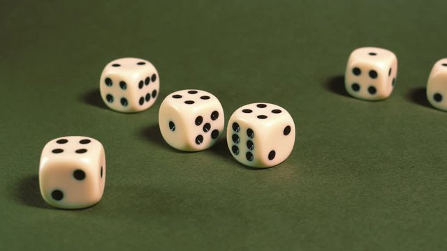 Game dice thrown on green table