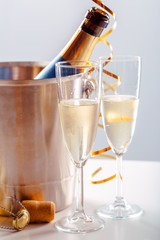 Pair glass of champagne with bottle in metal container. New Year celebration