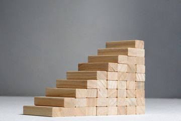 stairs build with wooden blocks on grey background