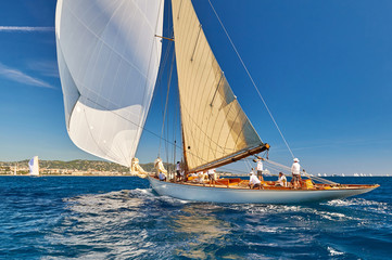 Sailing boat with spinnaker sail on open sea