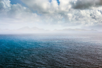 Coastline in the mist along a Saint Kitts and Nevis island in Caribbean sea