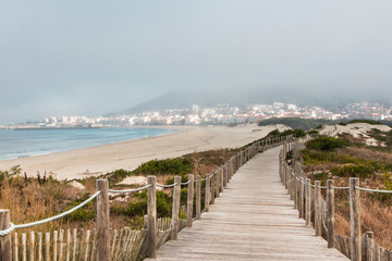 Wooden footpath at the beach. Portugal