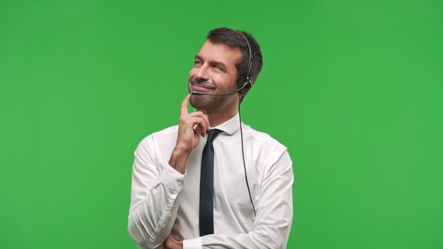 telemarketer man standing and thinking an idea pointing the finger up  on green screen chroma key background