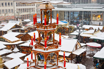 Traditional German christmas market in the historic center of a city in Germany during snow....