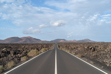 Road in the volcanic area Timanfaya National Park, Lanzarote, Spain