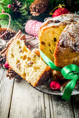 Traditional Christmas panettone with dried fruits and nuts, on old wooden background wth christmas...