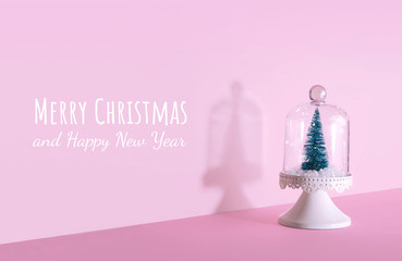 Creative Christmas design on pink pastel color background with Christmas tree.