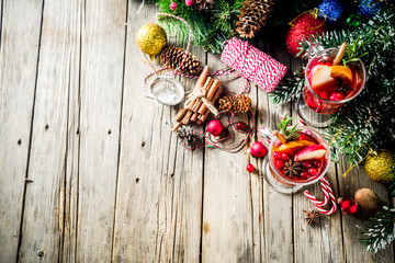 Traditional Christmas Mulled wine, grog or hot spicy sangria cocktail, on old rustic wooden table...