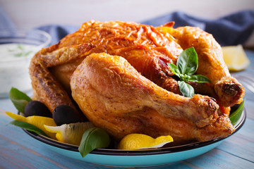 Chicken with yogurt sauce on blue wooden background. horizontal