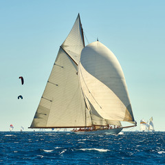 Obraz premium Sailboat under white sails at the regatta. Sailing yacht race