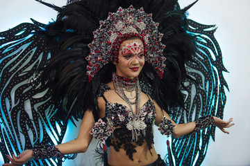 Portrait of a young beautiful woman in a creative look. The style of carnival and dancing.