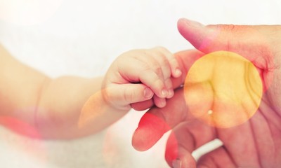 Close up photo of father holding baby hand