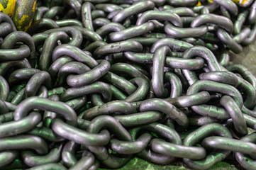 A pile of metal chains lying on the floor for work in the industry.