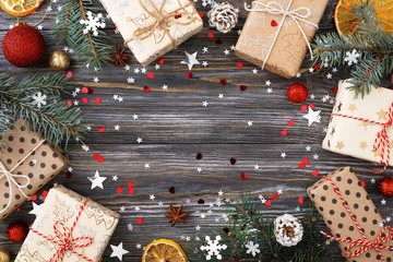 Christmas gift boxes over decorated festive table with sparkle stars and ornaments. Frame of...
