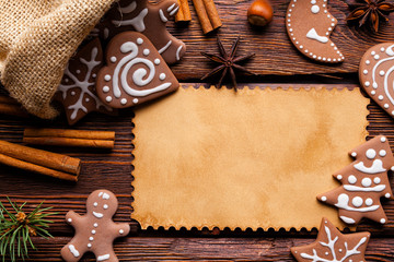 Blank paper card, gingerbread Christmas cookies and spices on wooden background