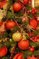 Traditional christmas or new year decorated fir tree with red baubles